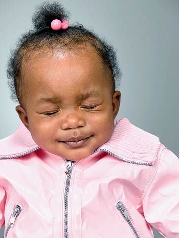 baby girl in jacket with eyes closed